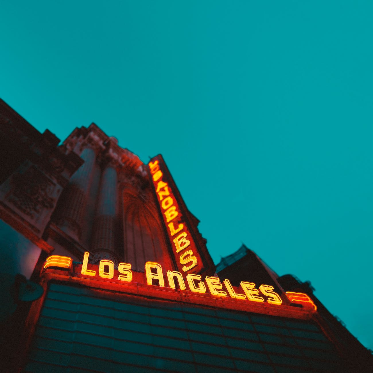 low angle photography of brown building with los angeles led sign