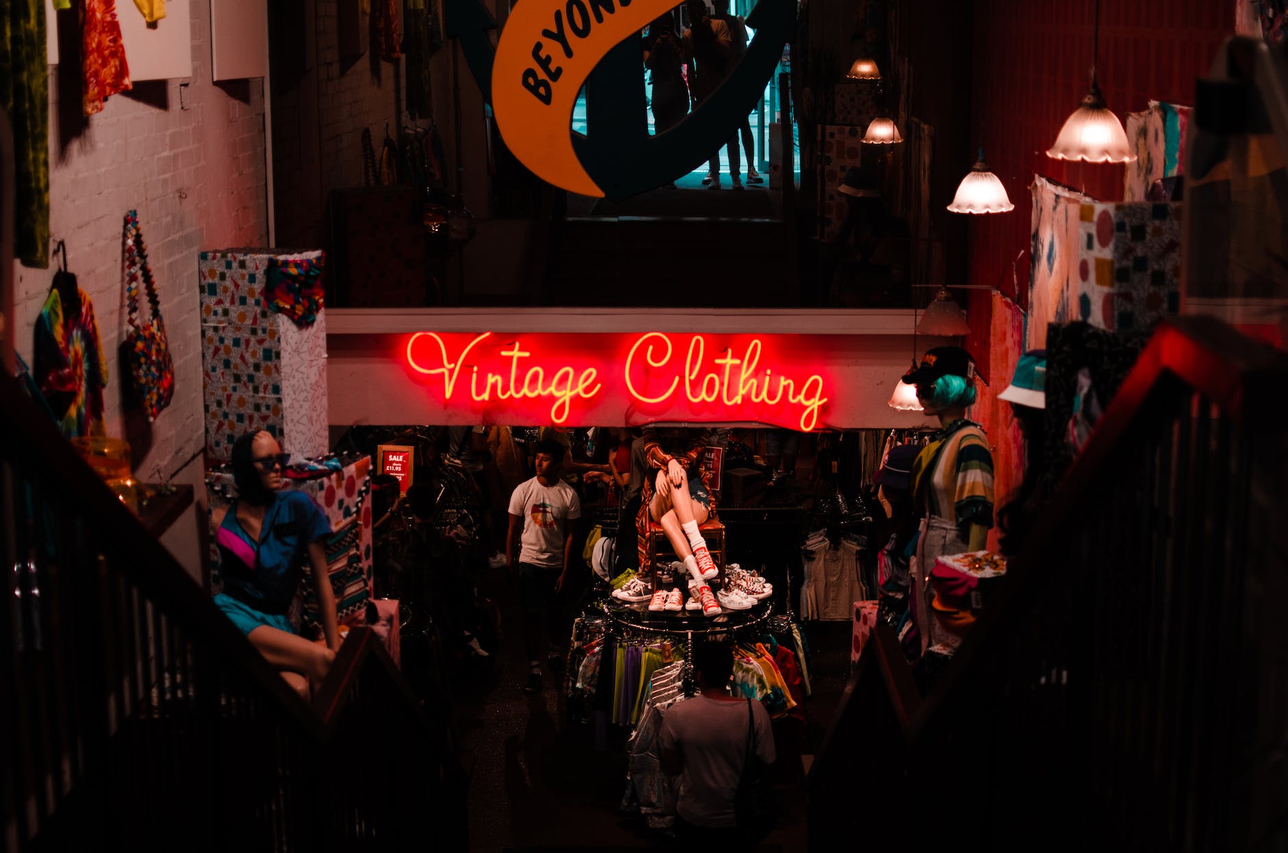 neon sign in shop with vintage clothes